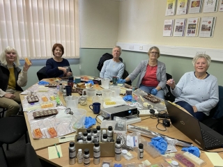 Volunteers making wax melts